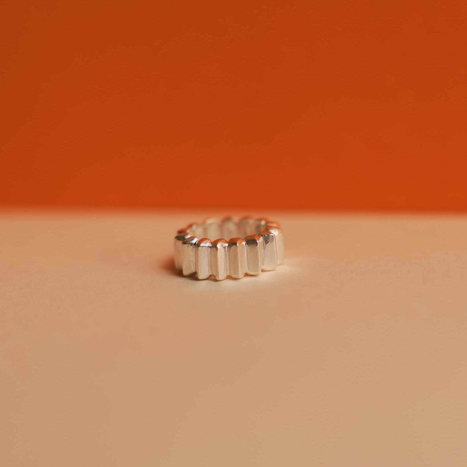 Silver ring on a peach background